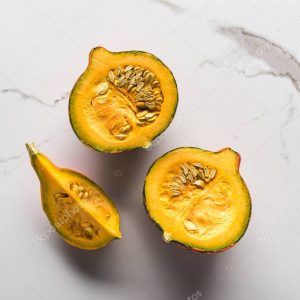 top view of raw pumpkin pieces on marble surface