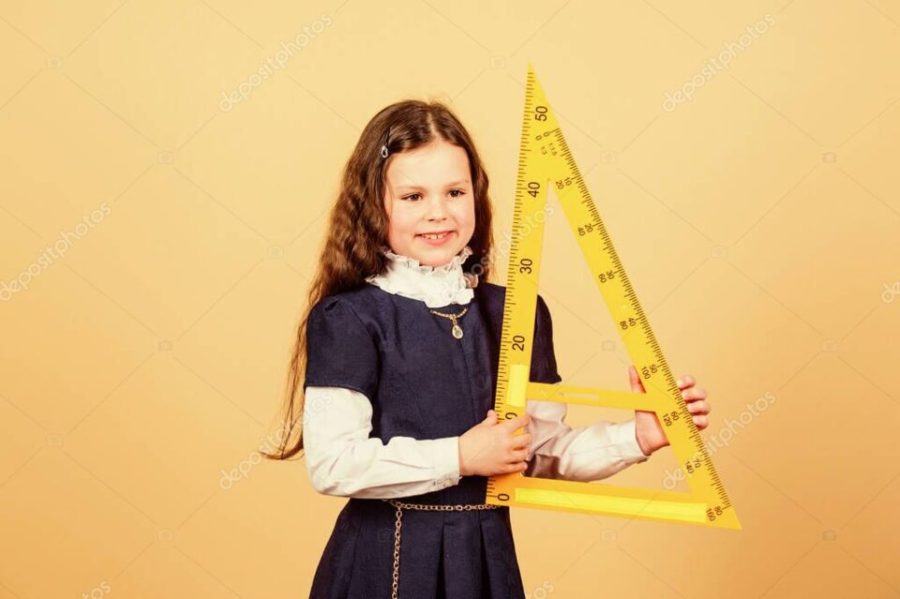 School student learning geometry. Pupil girl with big ruler. STEM school disciplines. small girl back to school. math lesson. Education and knowledge. Confident graduate