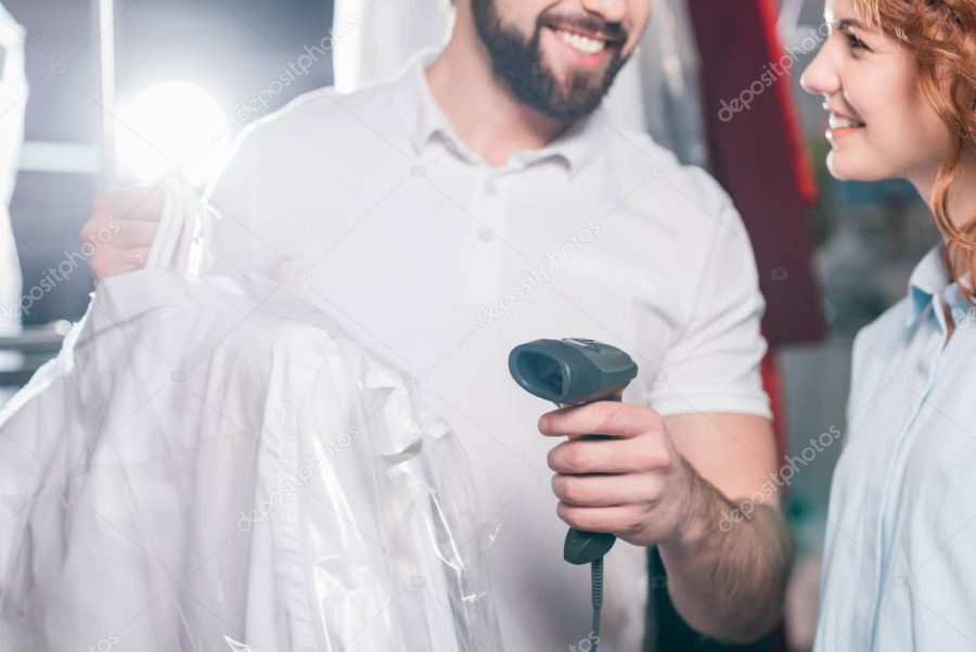 cropped shot of dry cleaning workers scanning bag with clothes