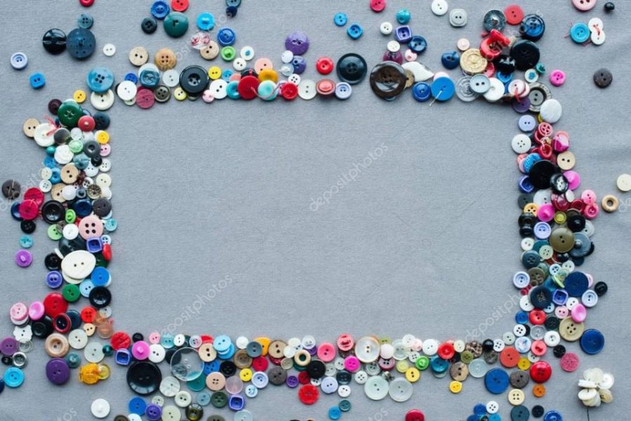 top view of colorful buttons frame on grey cloth background