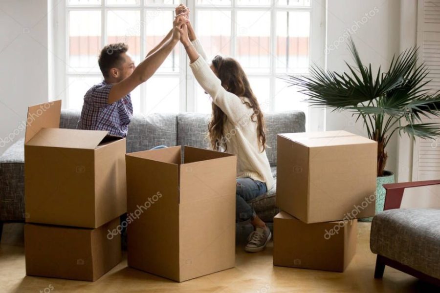 Excited couple holding hands happy to move into new home