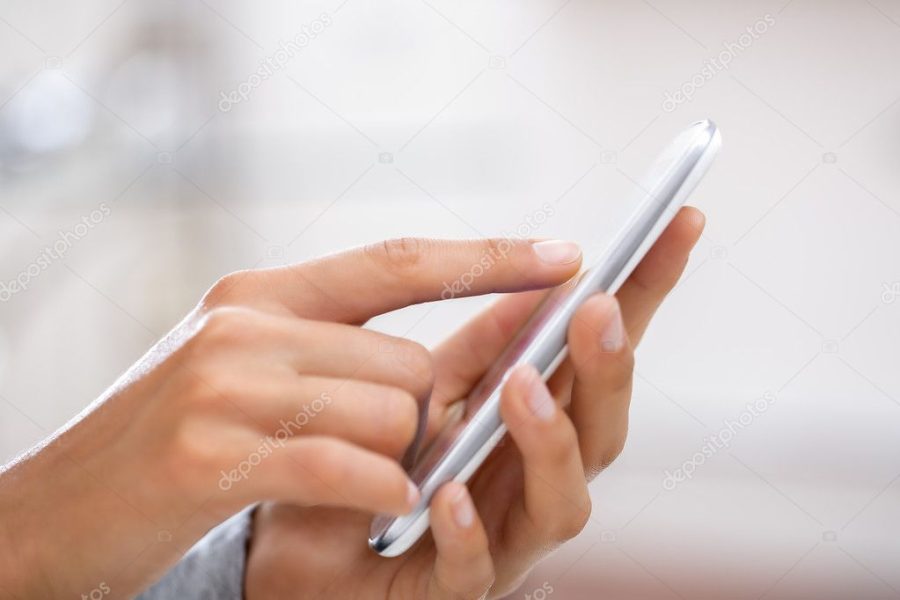 Close up of hands woman using cell phone.