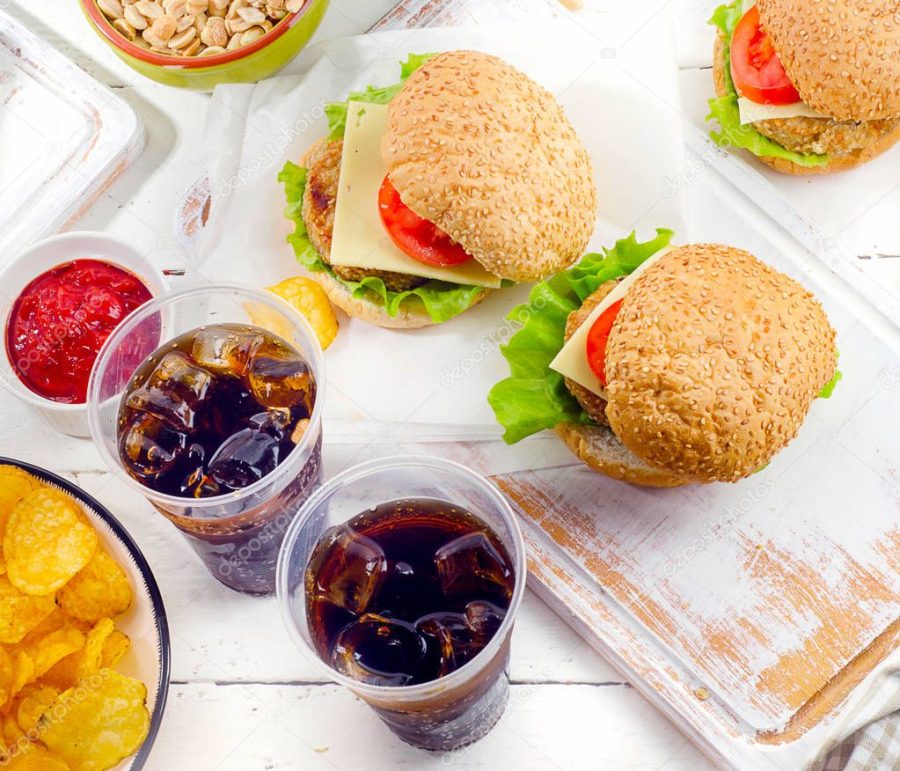 Fast food and cola in plastic cups