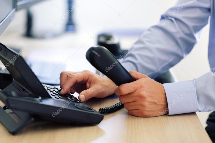 Man dialing telephone keypad