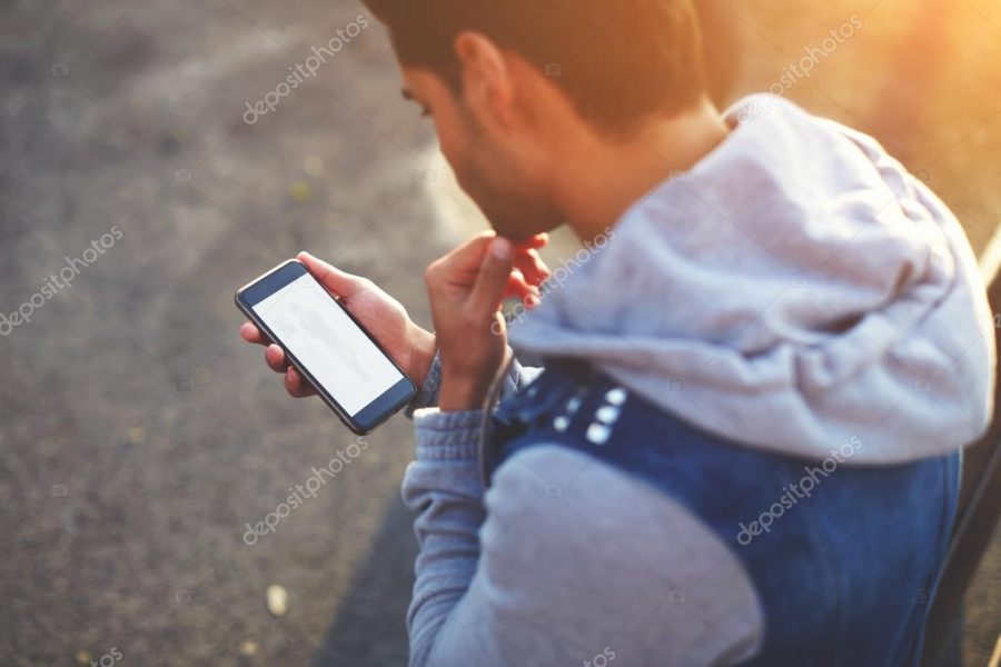 Man using phone while standing outdoors