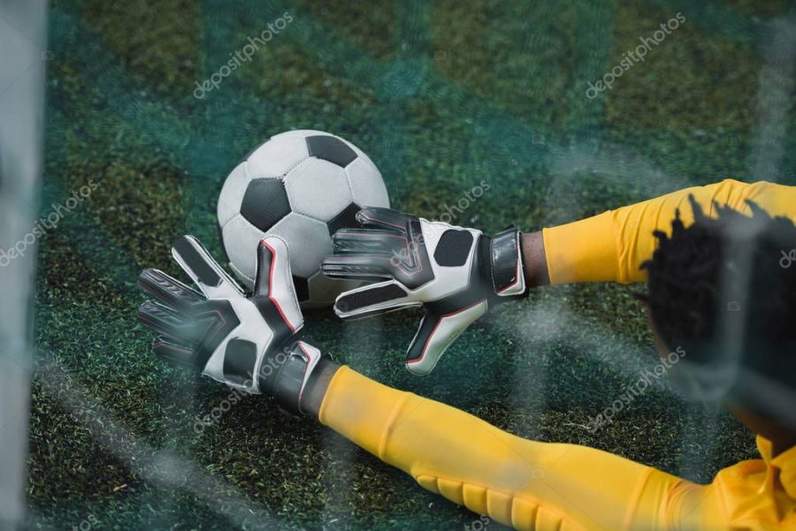 african american goalkeeper on pitch