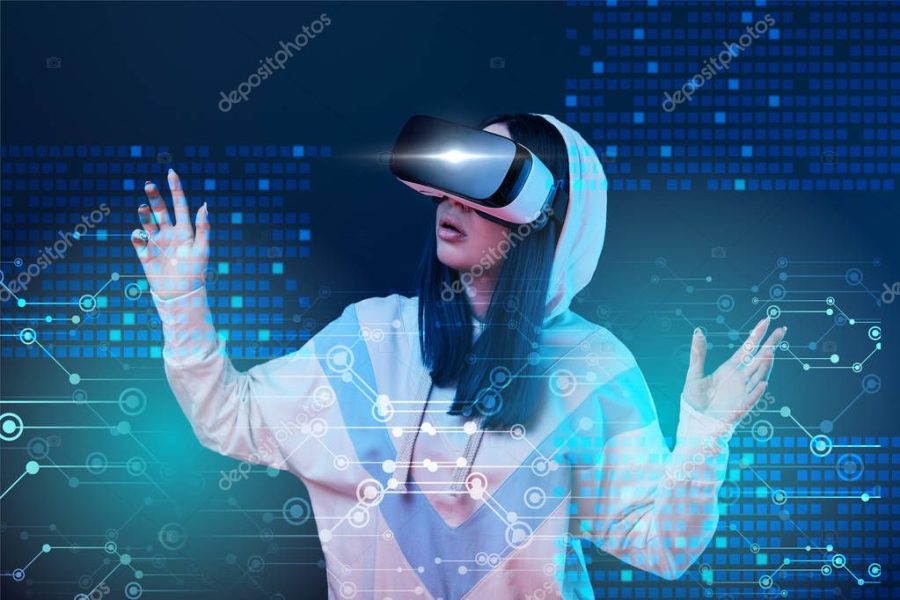 excited young woman in vr headset gesturing near glowing data illustration on dark background