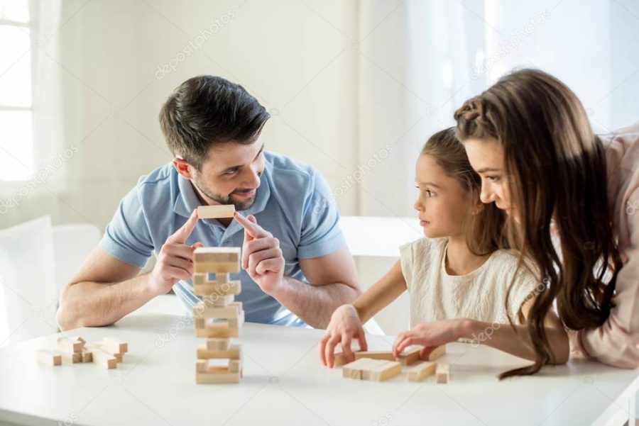 family playing jenga game