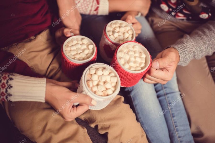 family with cups of cacao and marshmallow