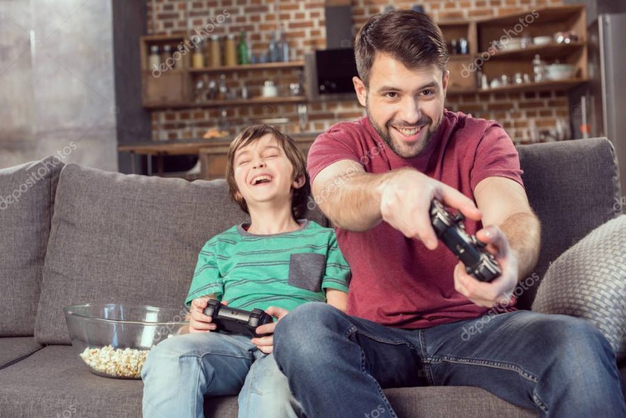father and son playing video game
