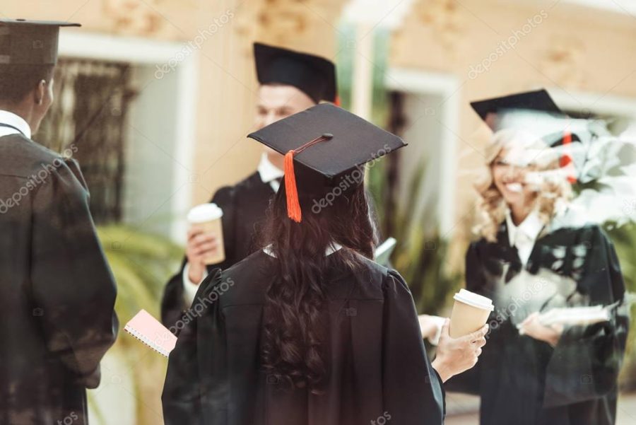 multiethnic students in graduation costumes