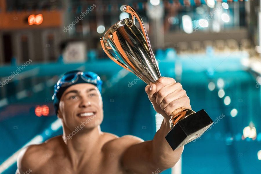 swimmer with trophy cup