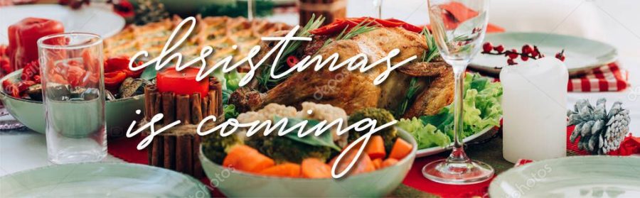 table served with delicious pie, roasted turkey and vegetables near christmas is coming lettering near candles, banner