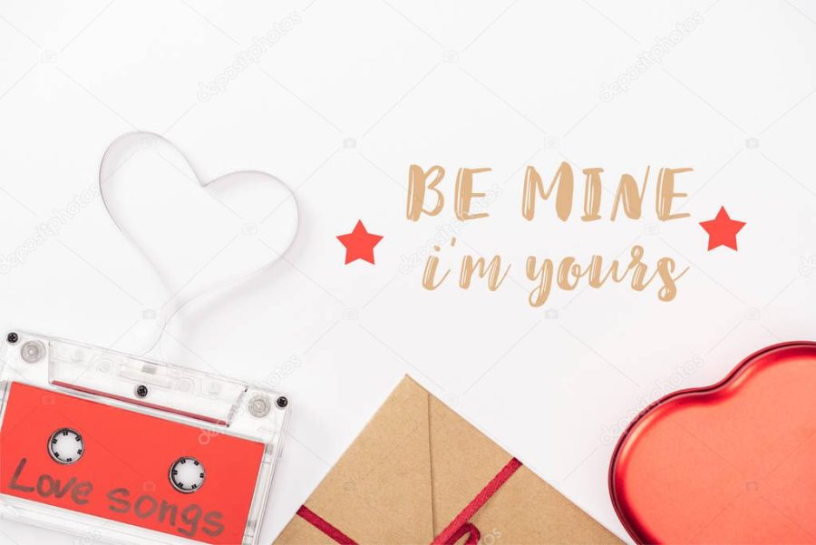 top view of audio cassette with 'love songs' lettering and heart symbol isolated on white, st valentines day concept with "be mine i am yours" lettering