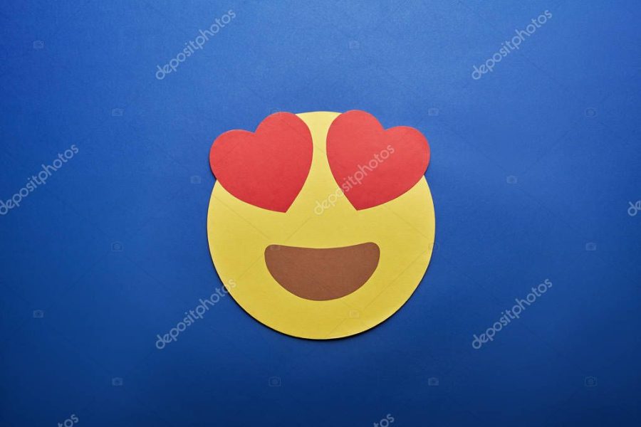 top view of in love emoji on blue background