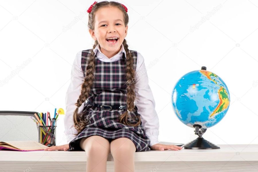 Happy schoolgirl sitting with globe