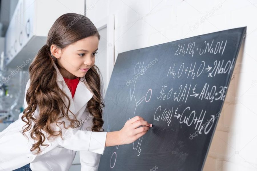 Little girl writing chemical formula