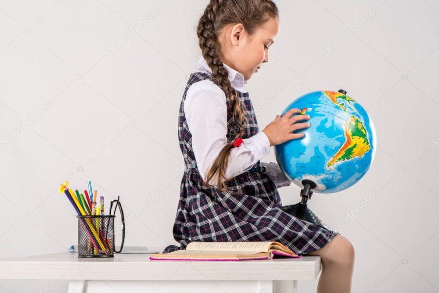 Schoolgirl using globe