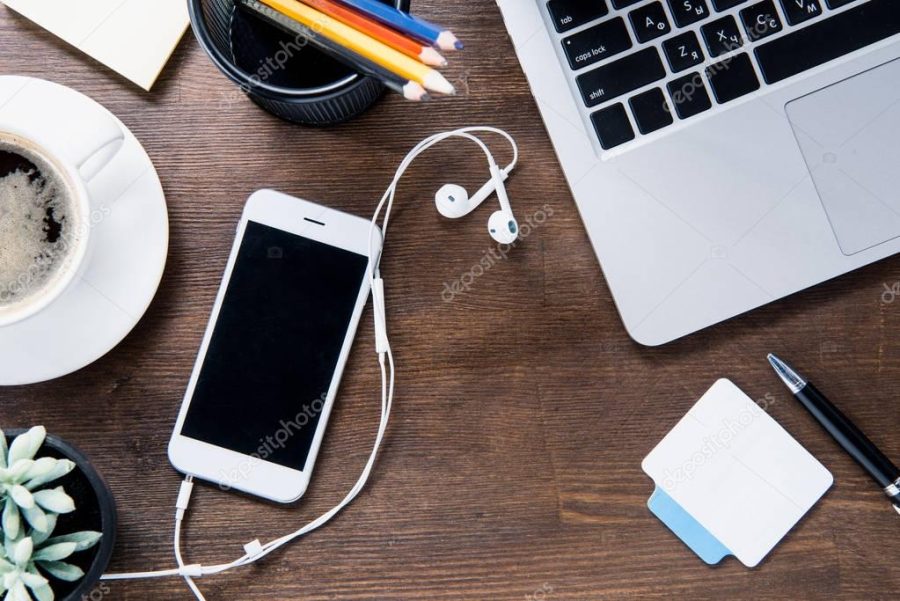 Coffee cup and smartphone on desk