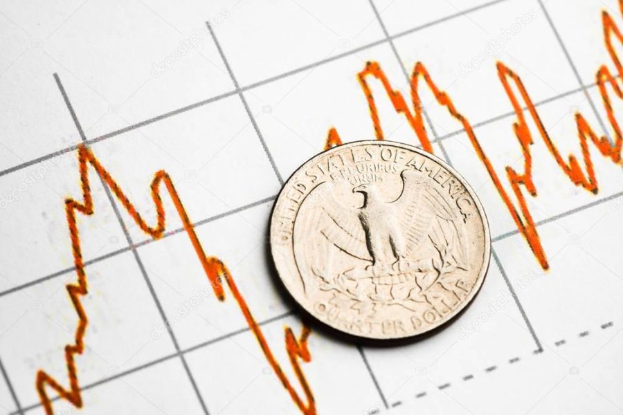 one dollar coin on fluctuating graph. Rate of the us dollar (shallow DOF)