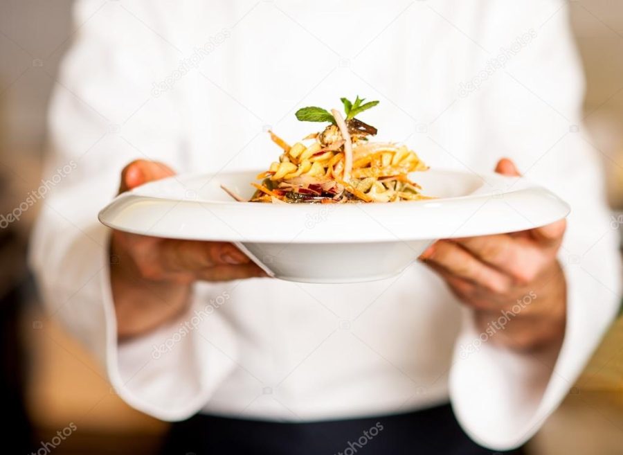 Chef offering pasta salad to you