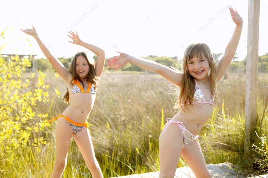 Girls dancing outside in the park in bikini