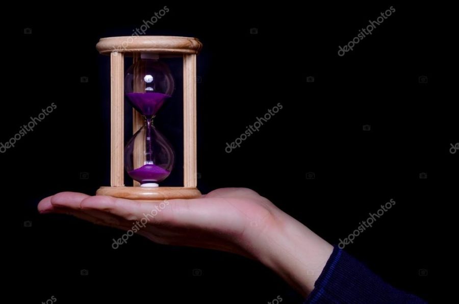 Hand holding an egg timer