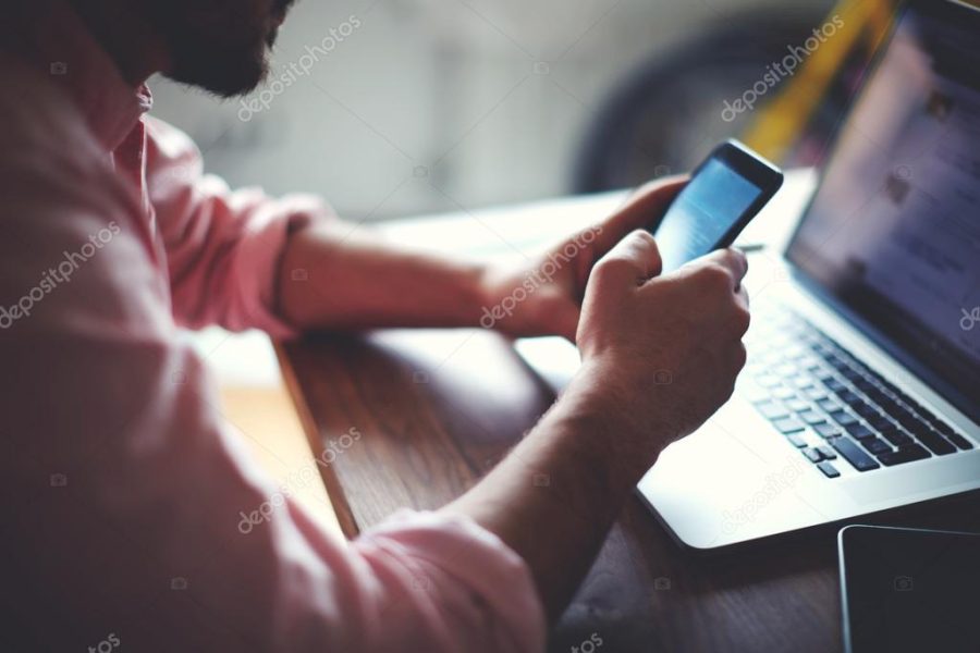 Man's hands using smart phone