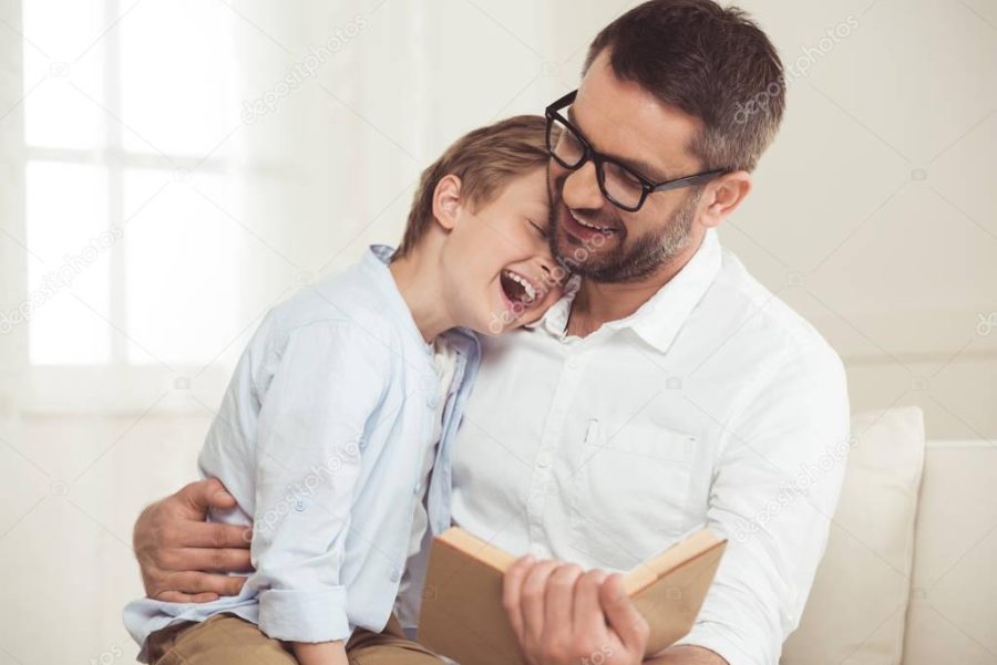 father and son reading book