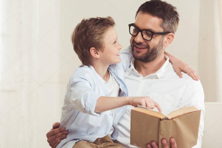 father and son reading book