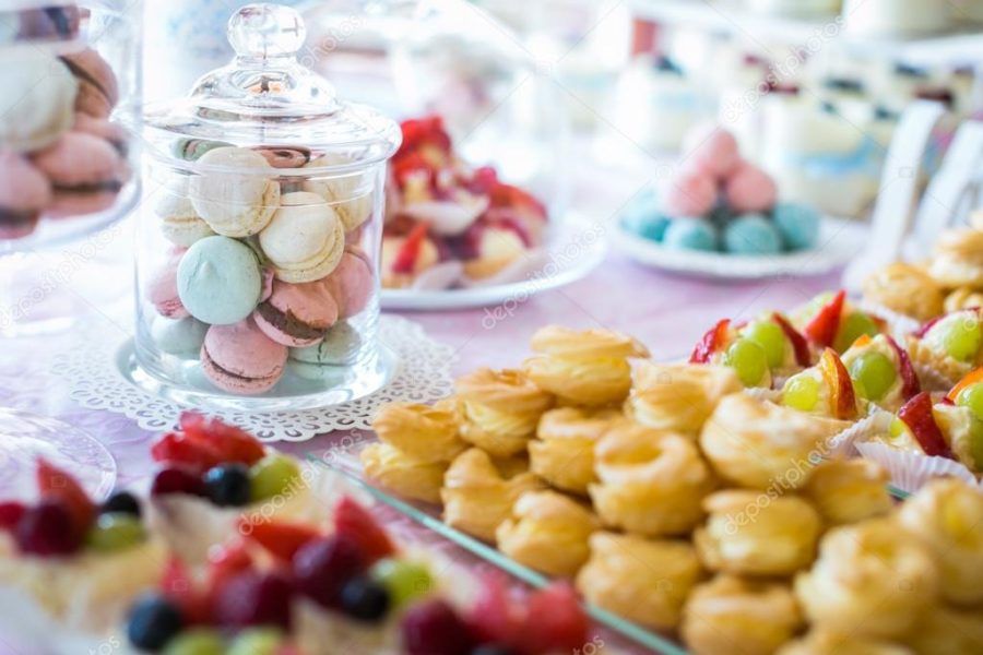 Table setting. Colorful macarons and cakes.