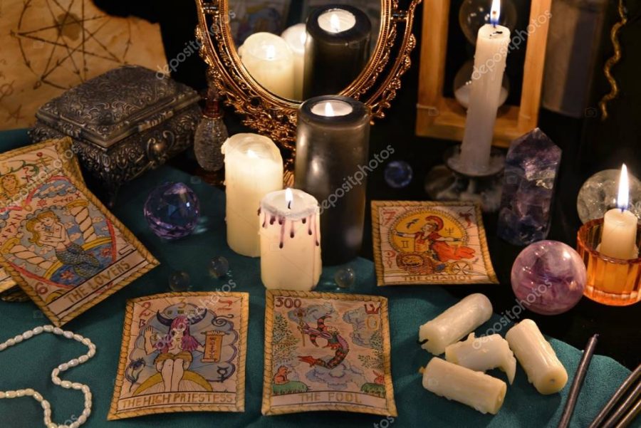 Tarot cards, mirror and burning candles.