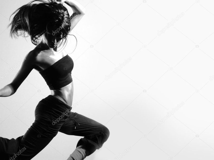 Young and sexy modern dancer over grey background