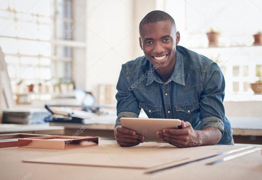 business owner leaning on work table