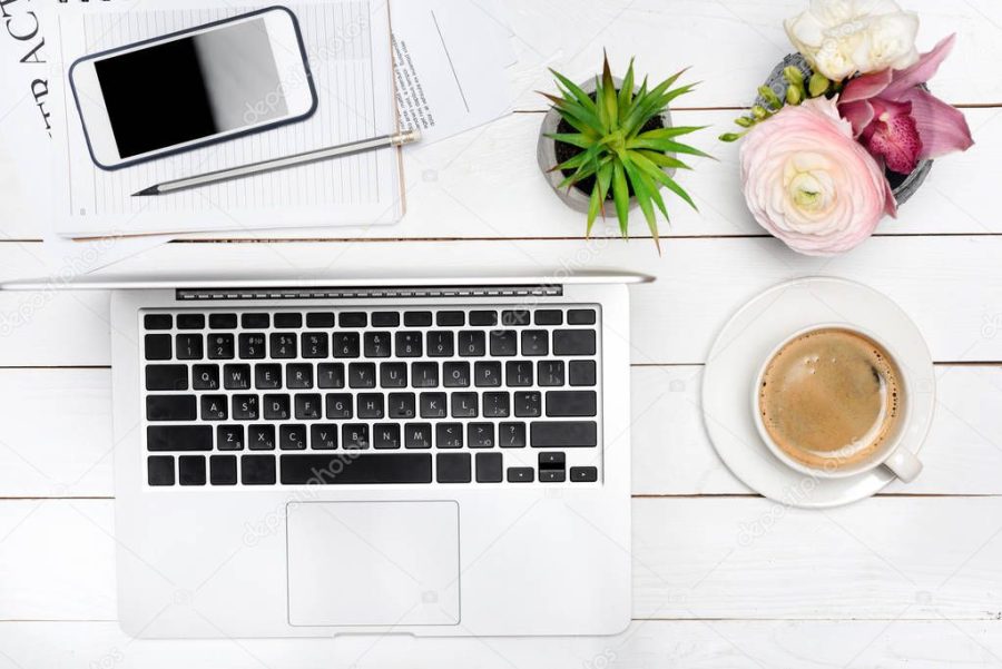 Laptop and cup of coffee on desk