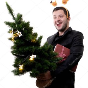 Photo of man in rim with deer with Christmas tree and gift in hands