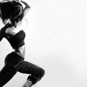 Young and sexy modern dancer over grey background