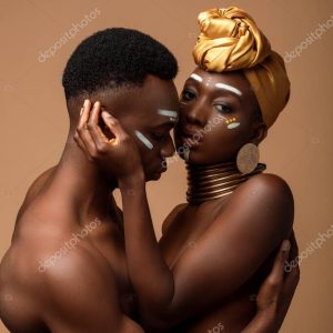 sexy naked tribal afro couple posing isolated on beige