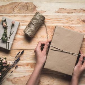 woman decorating christmas gift