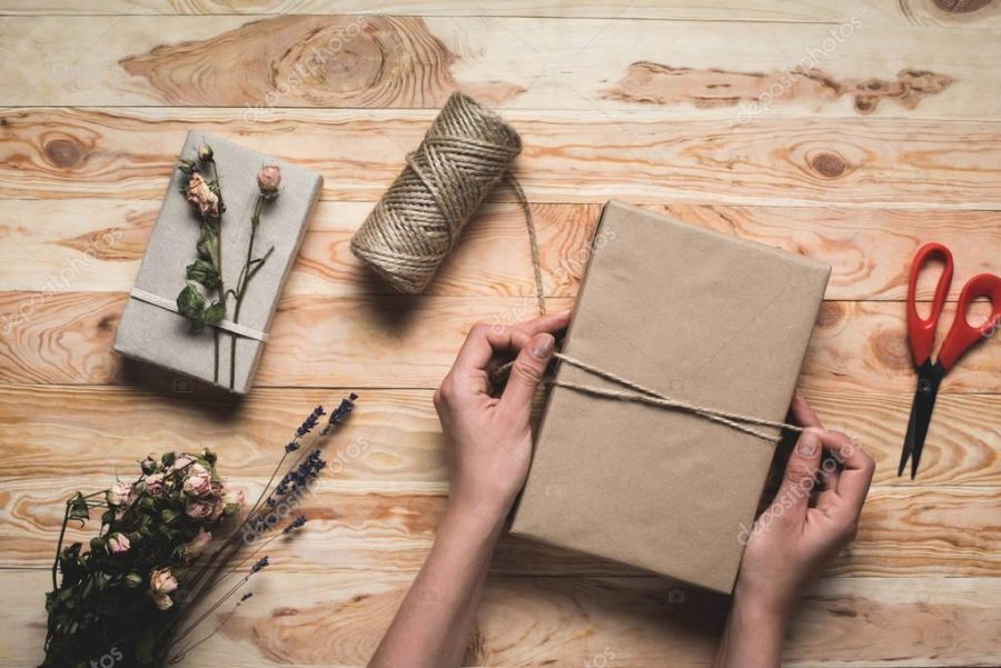 woman decorating christmas gift