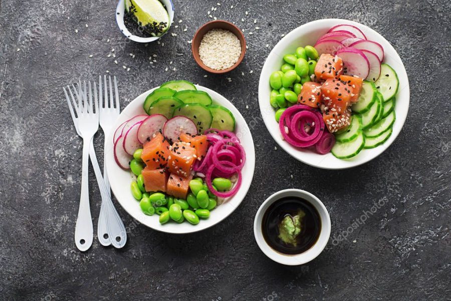 Fresh seafood recipe. Shrimp salmon poke bowl with fresh prawn, brown rice, cucumber, pickled sweet onion, radish, soy beans edamame portioned with black and white sesame. Food concept poke bowl