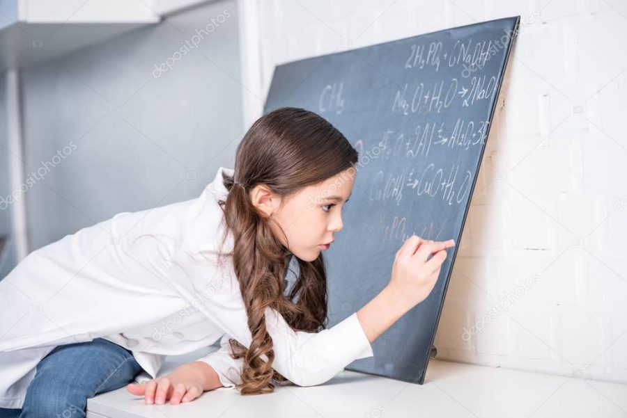 Little girl writing chemical formula