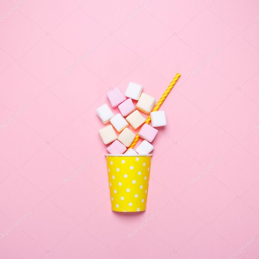 Top view of the pastel marshmallows on a pink background. Minimal style.