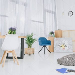 Room interior with working table and bicycle by the wall