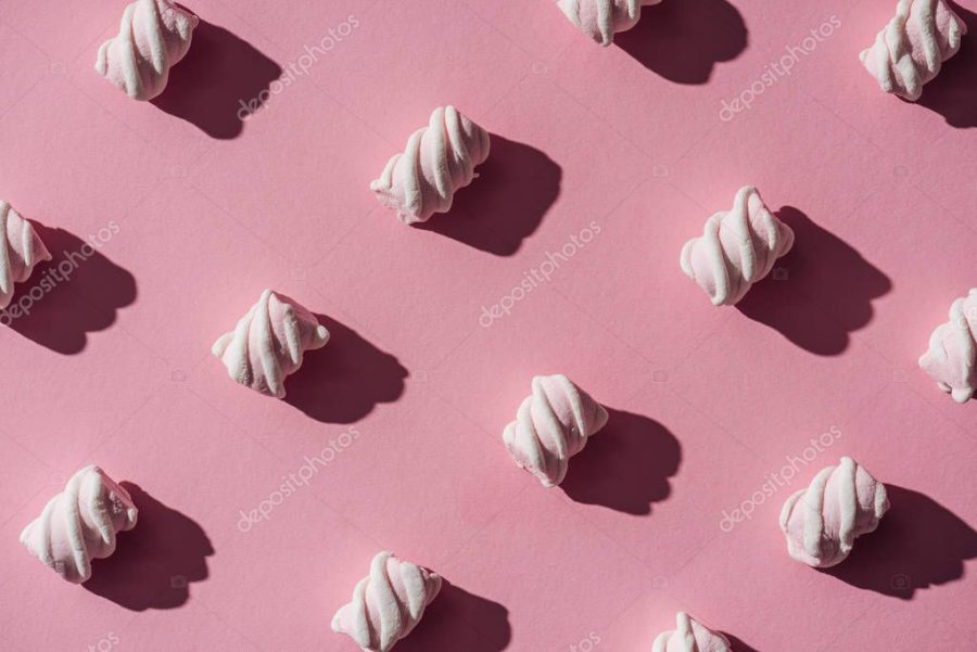 collection of delicious marshmallows with shadows on pink