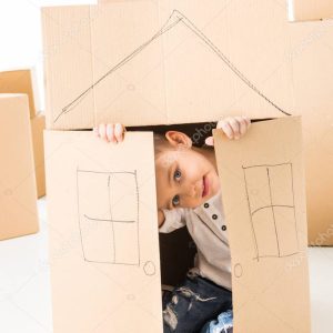 Boy sittling inside of cardboard box