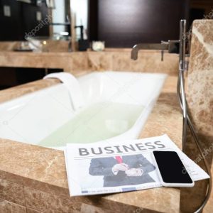 Business newspaper on bathtub