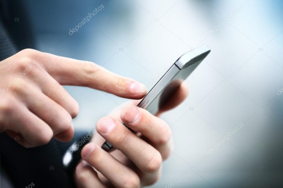 Close up of a man using mobile smart phone