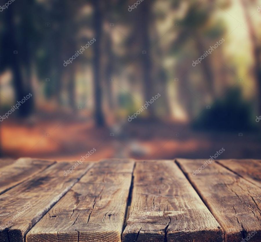 Image of front rustic wood boards and background of trees in forest. image is retro toned