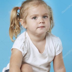 Little girl sitting on floor.